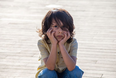 Portrait of a girl sitting outdoors