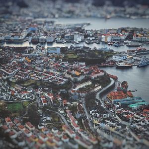 High angle view of city by river against buildings