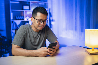 Man using smart phone at desk