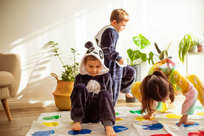 Siblings playing at home