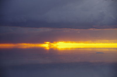 Scenic view of dramatic sky over sea during sunset