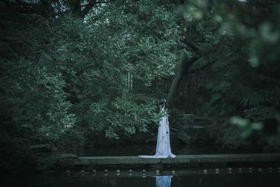 Woman standing by lake