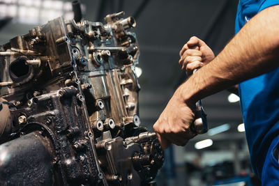 Close-up of man repairing machinery