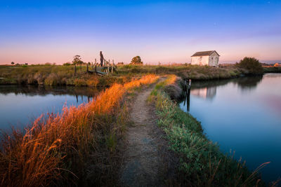 Scenic view of lake against sky during sunset