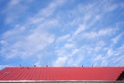 Low angle view of building against cloudy sky