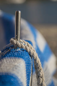 Close-up of rope tied on wood