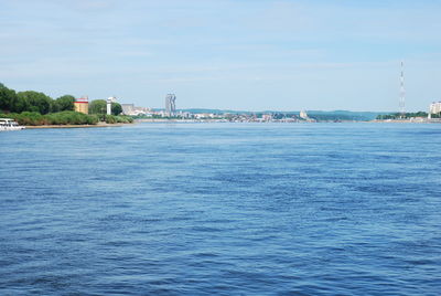 Scenic view of sea against sky in city