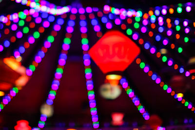 Low angle view of illuminated lighting equipment at night