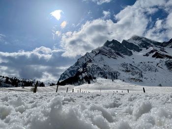 Scenic view of snow covered mountains against sky