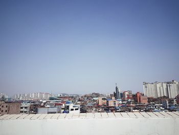 High angle view of buildings against clear blue sky