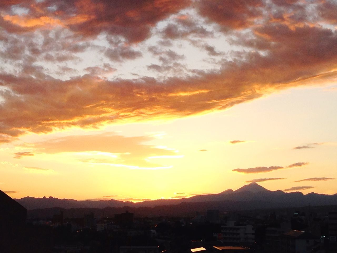 sunset, building exterior, architecture, built structure, cityscape, orange color, city, sky, mountain, cloud - sky, residential district, scenics, high angle view, residential structure, residential building, crowded, town, beauty in nature, house, cloud