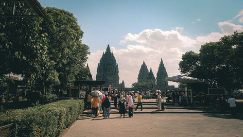 Group of people outside temple against building