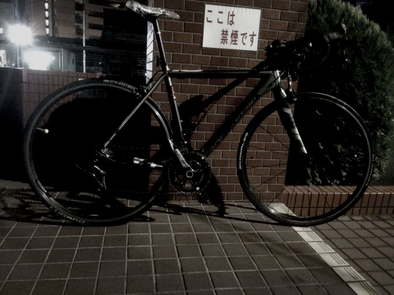 built structure, architecture, building exterior, bicycle, brick wall, land vehicle, low angle view, old-fashioned, metal, wall - building feature, transportation, circle, retro styled, wheel, mode of transport, outdoors, no people, old, stationary, day