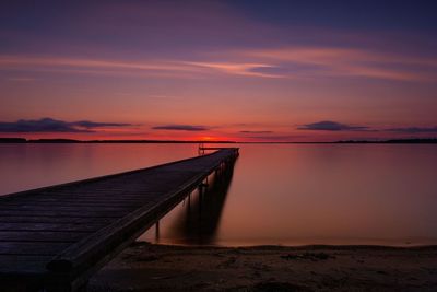 Scenic view of lake against romantic sky at sunset