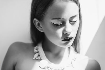 Close-up portrait of young woman with eyes closed