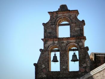 Low angle view of historic building against clear blue sky