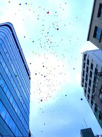 Low angle view of balloons against sky