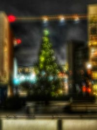 Defocused image of illuminated city at night