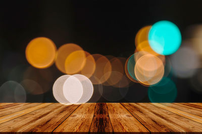 Defocused image of illuminated lights on table
