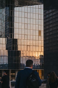 Rear view of people standing in modern building