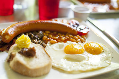 Close-up of english breakfast served in plate on table