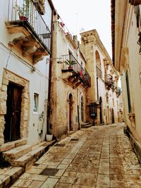 Narrow alley amidst buildings in city