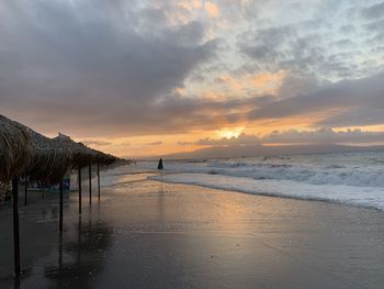 Scenic view of beach against sky during sunset