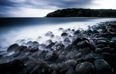 Scenic view of sea against cloudy sky