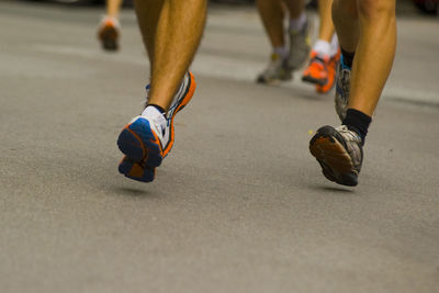 Low section of man running on road