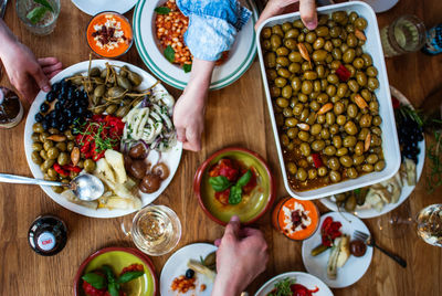 Cropped image of hands with food served on table