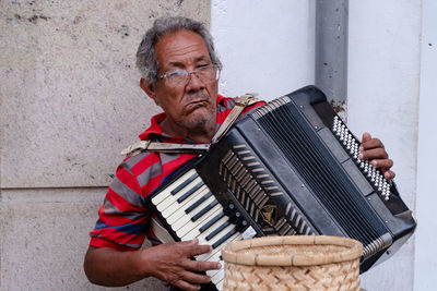 Senior man playing accordion