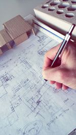 Cropped image of architect making blueprint