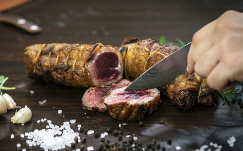 Close-up of person preparing food on table