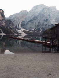 Scenic view of lake by snowcapped mountains against sky
