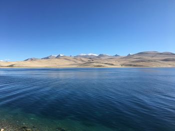 Scenic view of mountains against clear blue sky