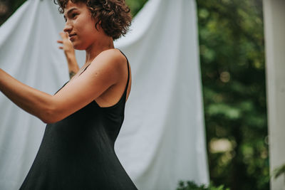 Midsection of woman standing against blurred background