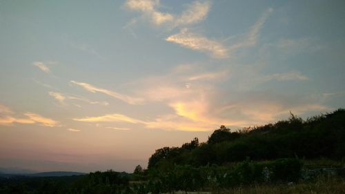 Scenic view of landscape against sky at sunset