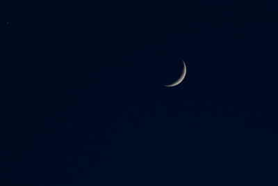 Low angle view of moon in sky at night