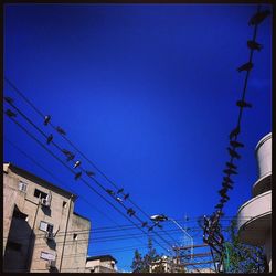 Low angle view of built structure against clear blue sky