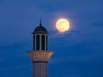 Low angle view of bell tower against sky during sunset