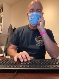 Midsection of man using mobile phone