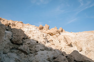 Low angle view of rocks against sky