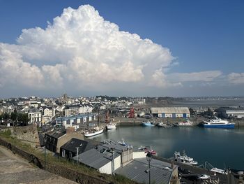 High angle view of townscape by sea against sky