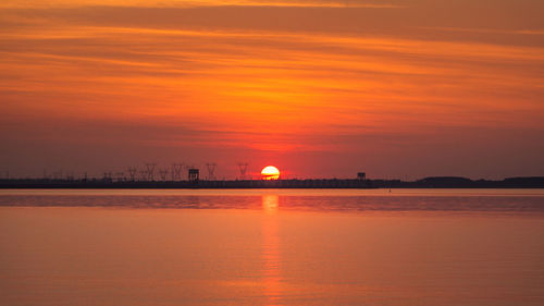 Scenic view of sea against romantic sky at sunset