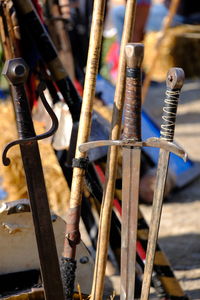 Close-up of rusty swords outdoors