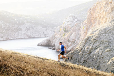 Rear view of man walking on mountain