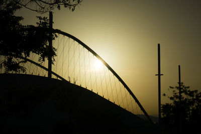 Low angle view of silhouette bridge against sky during sunset