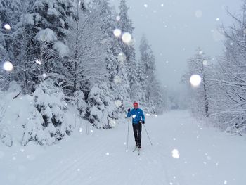 People walking on snow covered landscape