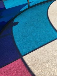 High angle view of tiled floor by swimming pool