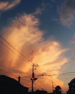 Low angle view of electricity pylon against sky